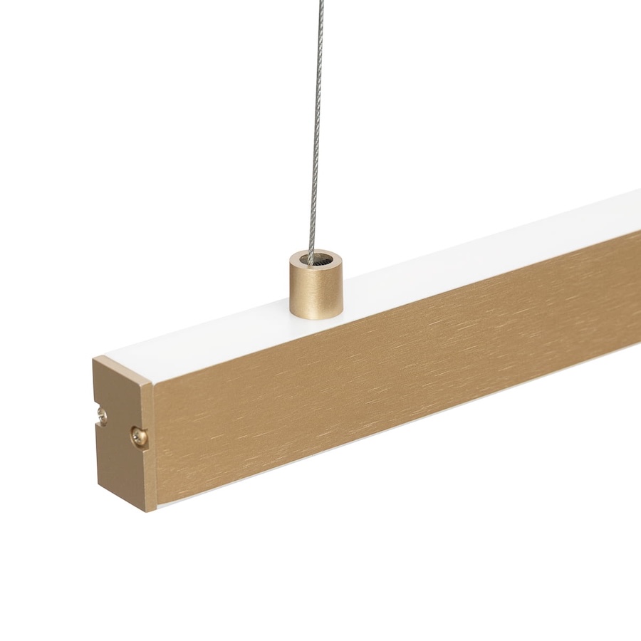 zlota waska dluga lampa wiszaca nad blat