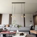 4-punktowa lampa wisząca Elit 4 - złote metalowe klosze - nad stolik kawowy w salonie