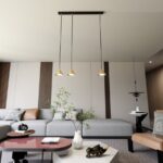 Elegancka lampa wisząca Elit 3 - trzy złote stożki - do salonu nad stolik kawowy