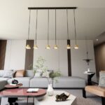 Lampa wisząca Elit 6 - złote klosze stożki - nad stolik kawowy w salonie